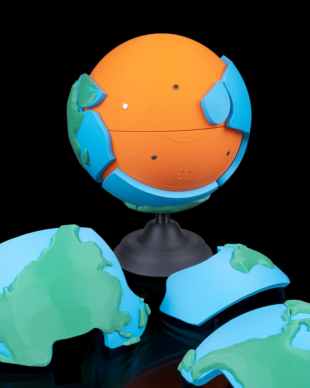 Magnetic Planet Puzzle colorful 3D printed globe with magnetic interlocking Earth pieces shown assembled and separated on a stand by 3DPRINTSWA from Puzzles