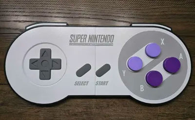 3D printed clickable SNES controller wall art with functional purple keyboard clicker buttons
