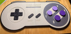 Large 3D printed SNES controller wall art for a retro gaming room