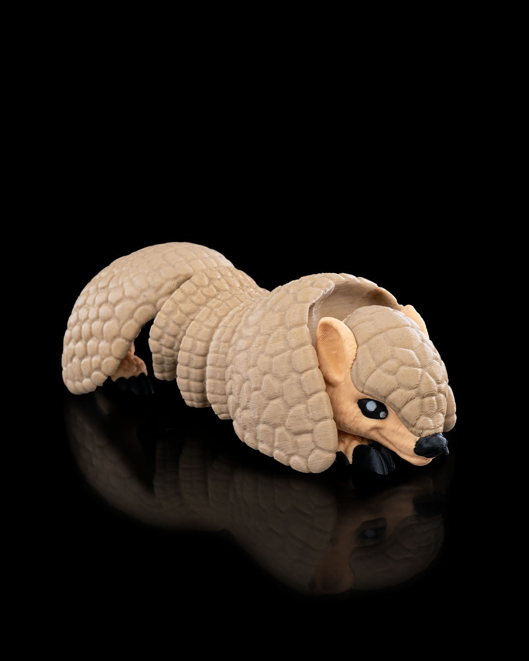 Armadillo articulated 3D printed toy with detailed scaly armor curled on a black reflective surface by 3DPRINTSWA from Articulated Animals