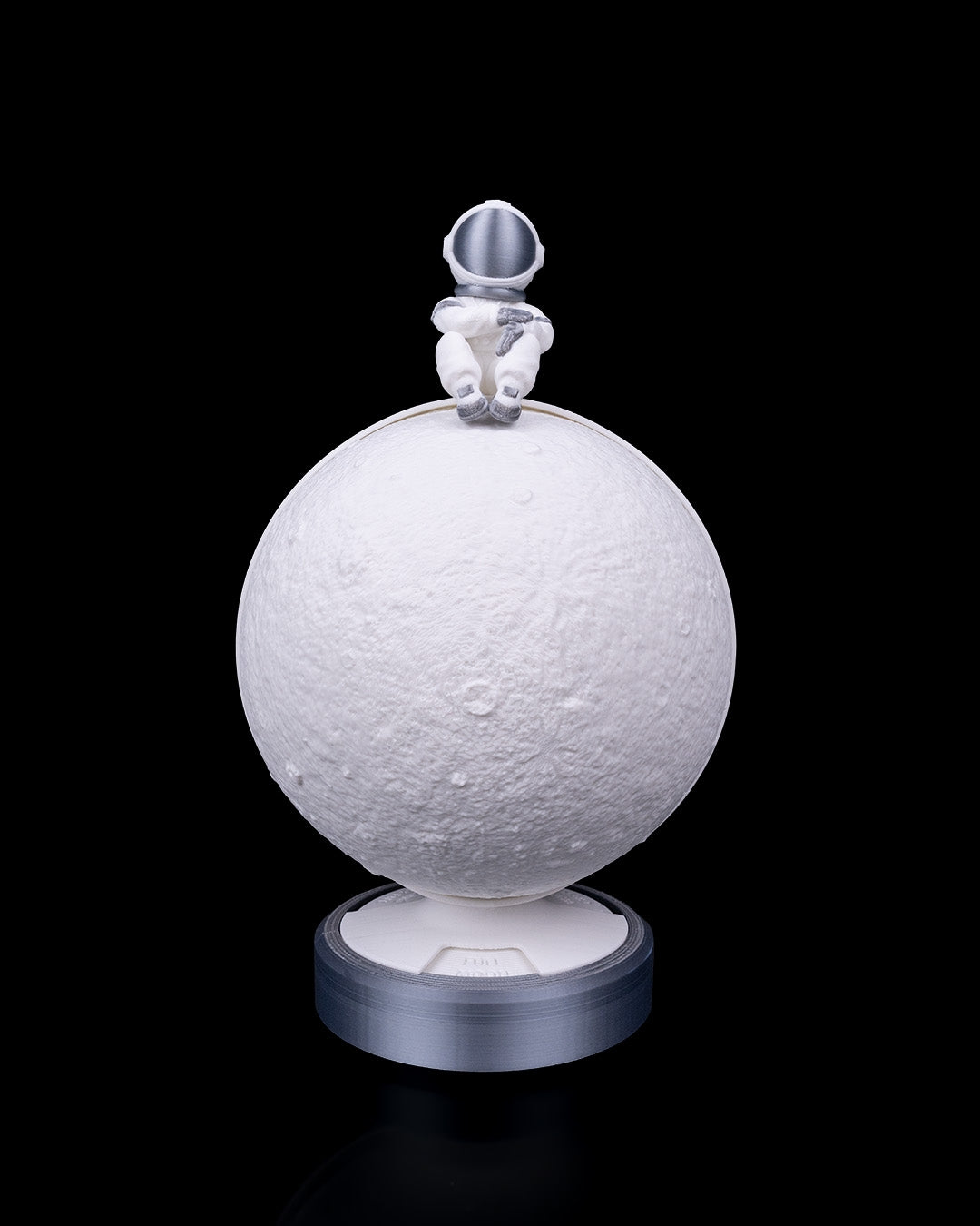 Bright Phases – Table Lamp featuring a textured illuminated moon with astronaut detail on a round base by 3DPRINTSWA from Lamps/Lights