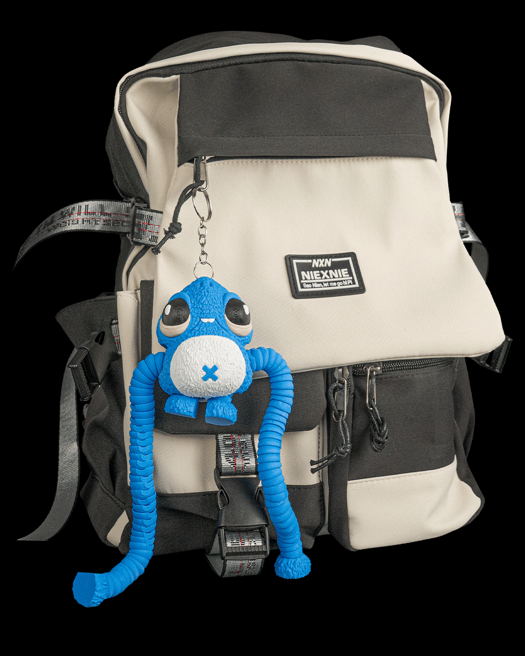 Gnasher blue articulated sea creature keychain hanging from a black and cream backpack by 3DPRINTSWA for fidgeting and display in Articulated and Keychains collections