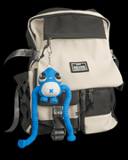 Gnasher blue articulated sea creature keychain hanging from a black and cream backpack by 3DPRINTSWA for fidgeting and display in Articulated and Keychains collections