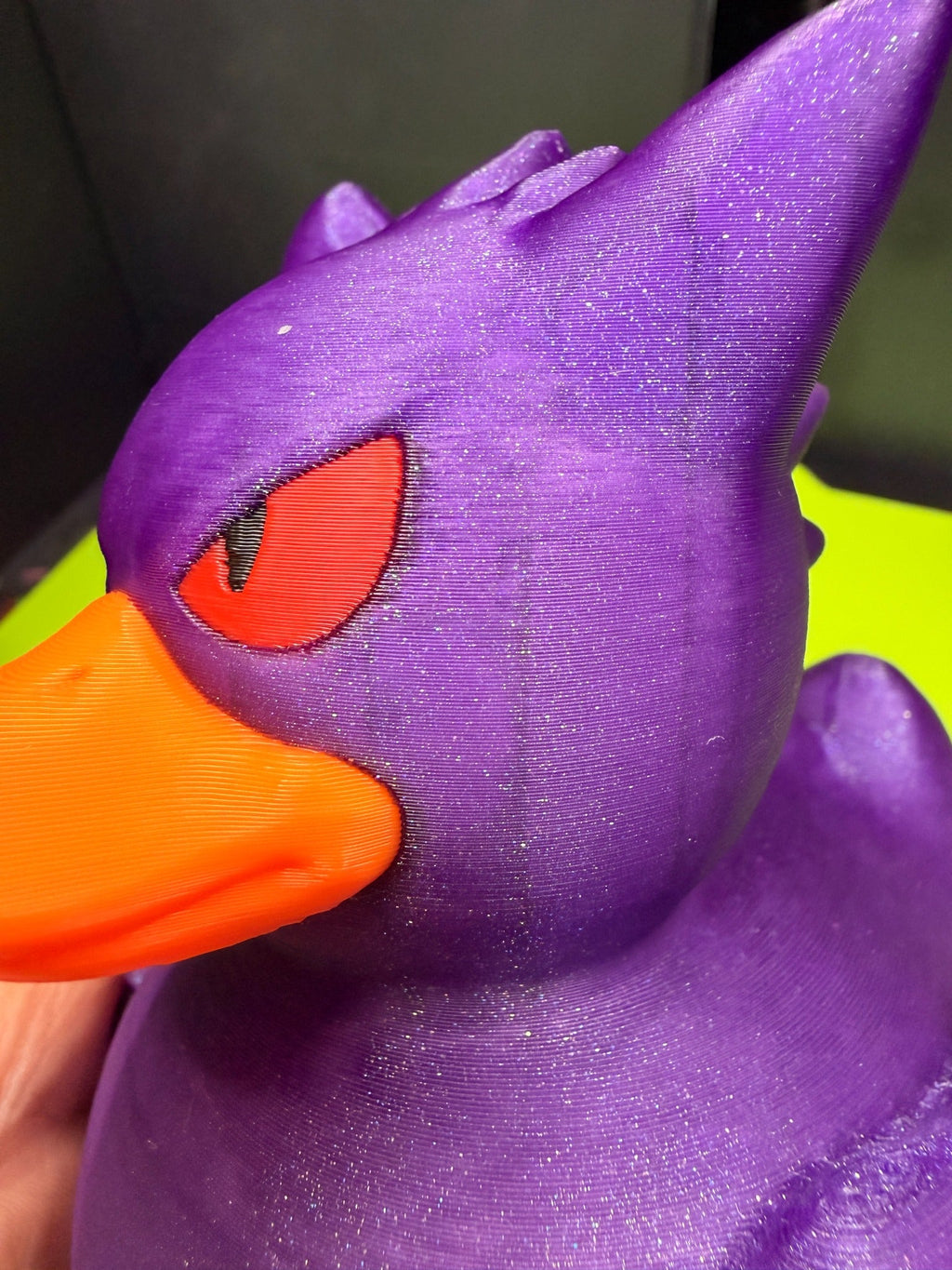 Close-up of 3D printed Gengar Duck Pokémon mashup figure showing purple head, red eye, and orange bill