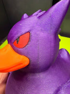 Close-up of 3D printed Gengar Duck Pokémon mashup figure showing purple head, red eye, and orange bill