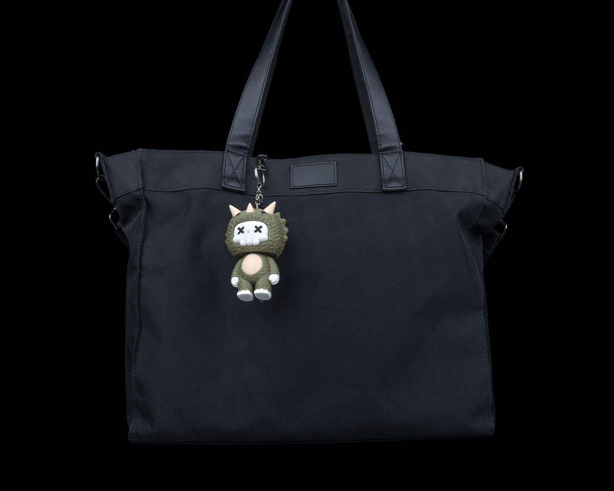 Trixi skeleton triceratops keychain charm attached to a black tote bag by 3DPRINTSWA in the Keychains Animals collection