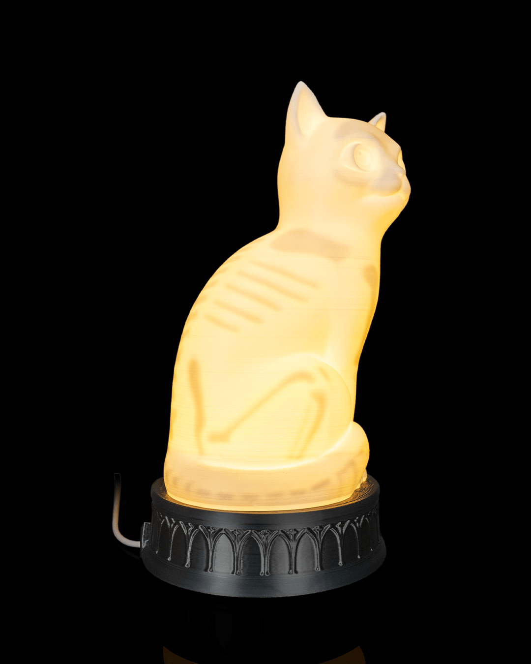 Side view of the glowing X-Ray Cat lamp with ribs and leg bones visible through its body