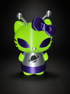 Angled front view of the PLA Alien Hello Kitty figure showing its purple skirt, green arms, and silver ringed-planet dress.