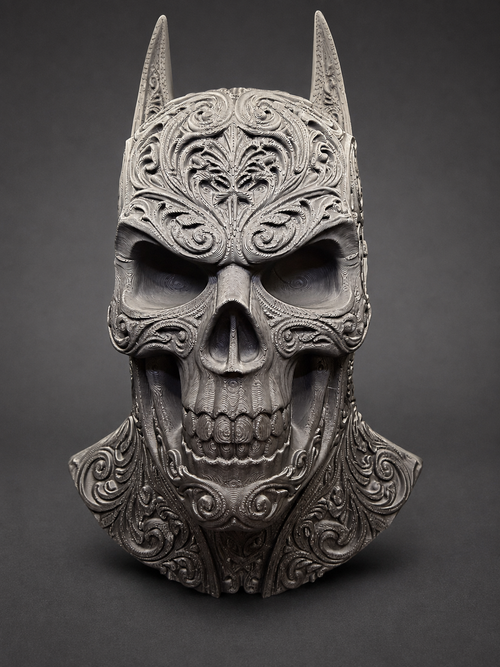 Upright front view of the Batman-inspired skull decor with pointed ears and ornate scrollwork against a dark background.