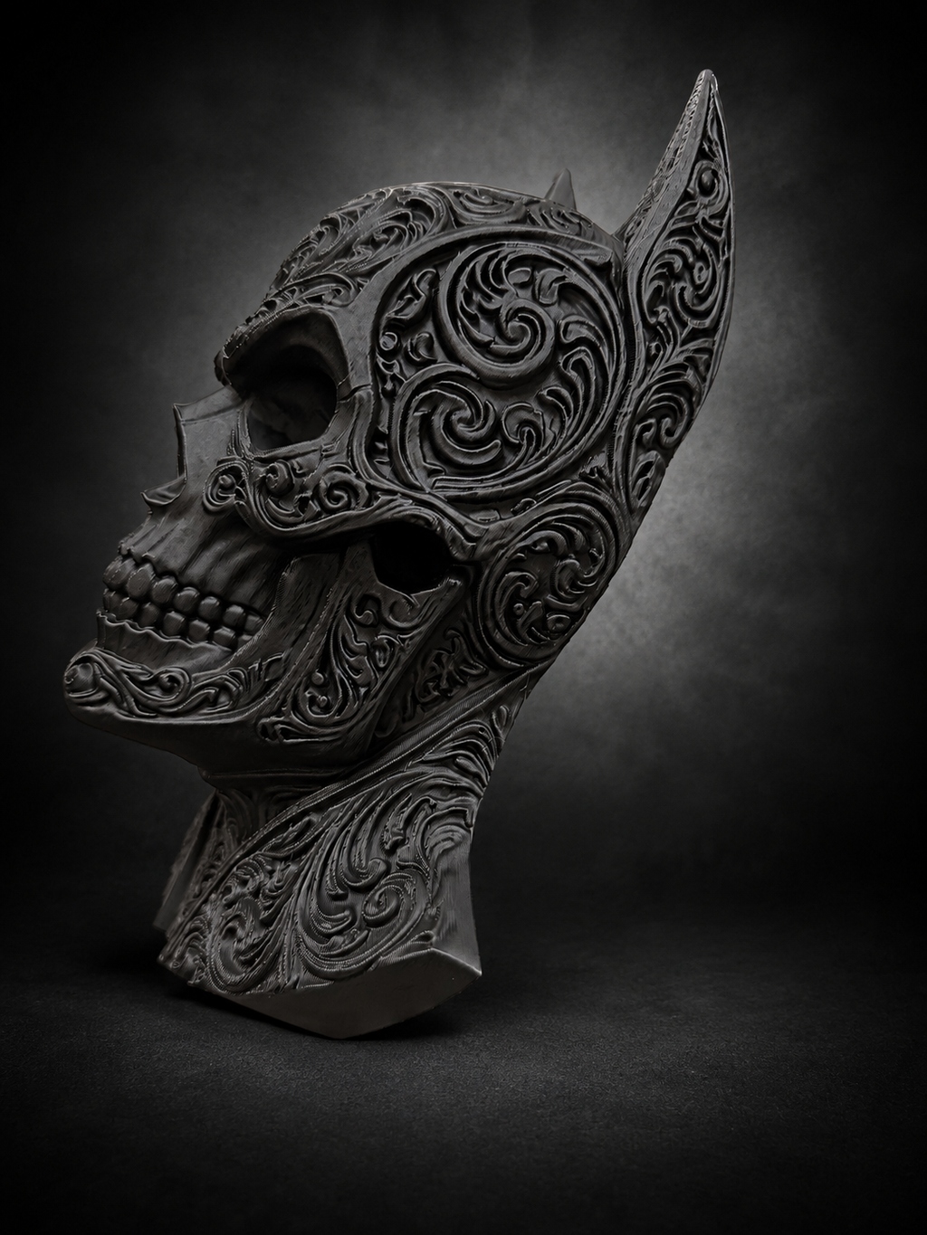 Side profile of the Batman skull decor showing its raised filigree, pointed ear, and sculpted jaw.