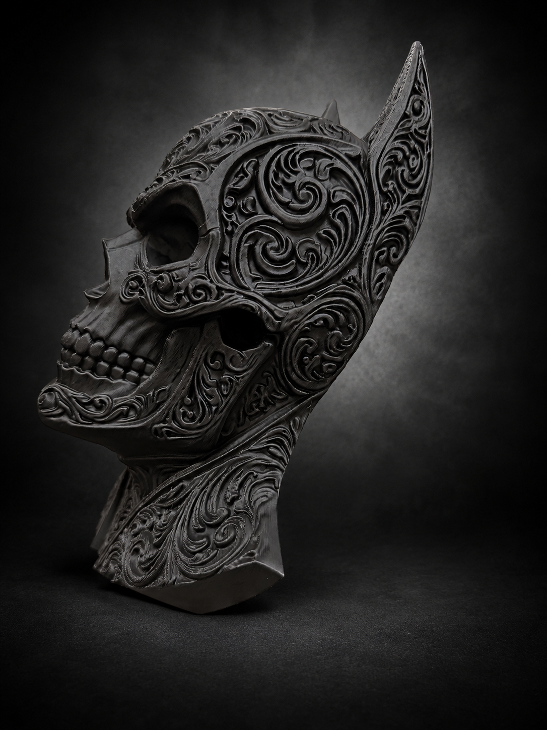 Side profile of the Batman skull decor showing its raised filigree, pointed ear, and sculpted jaw.