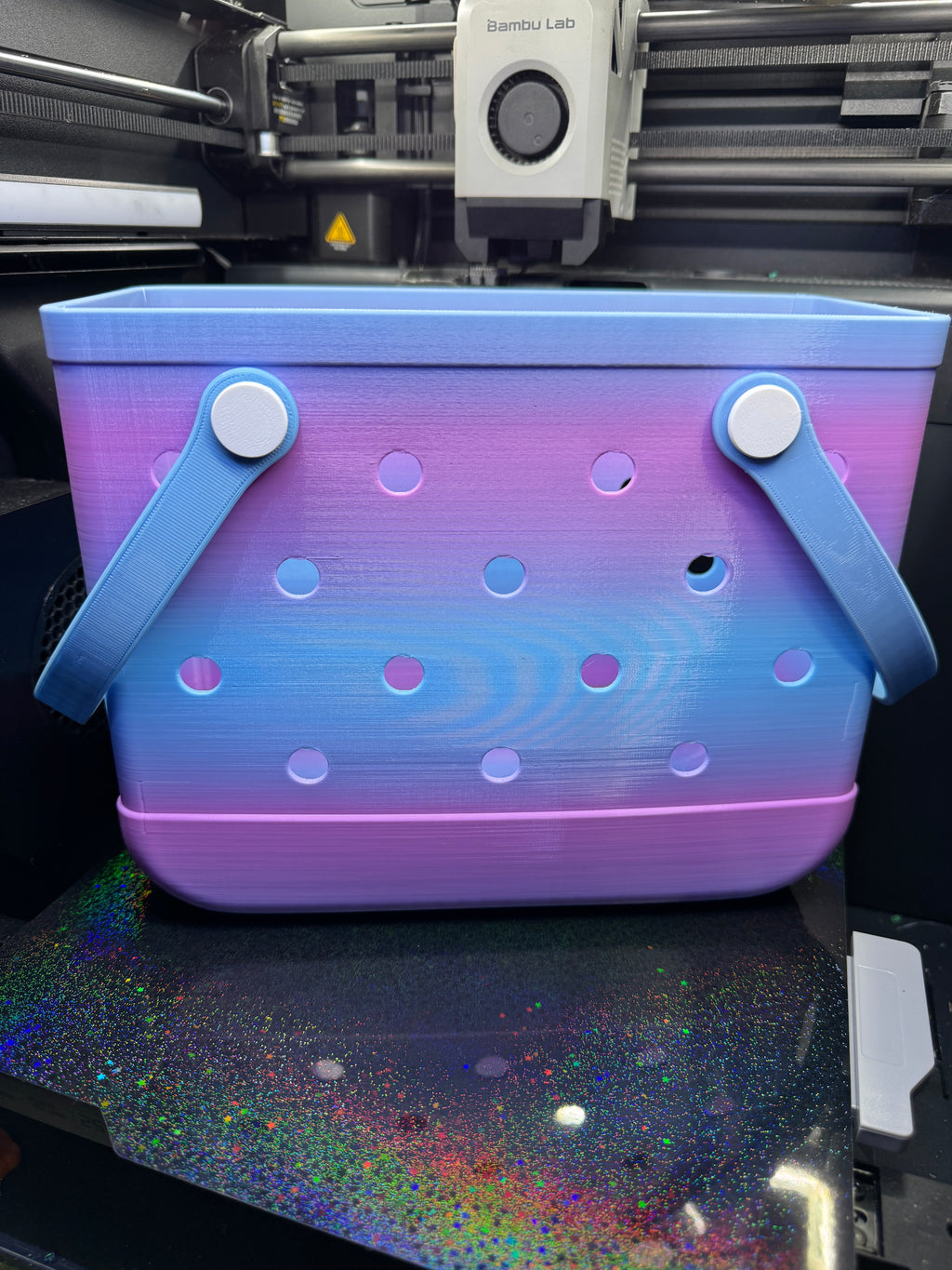 Front view of the assembled blue and purple TPU tote with blue handles and white attachment buttons.