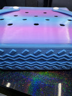 Close-up of the blue and purple tote's perforated side and textured zigzag base.