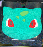 Overhead front view of Bulbasaur wall decor on a textured printer plate, showing the complete filigree design.