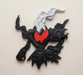 Front view of Darkrai Pokémon wall art with black raised filigree, red collar, white plume and blue eye.