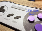 Close-up of 3D printed SNES controller wall art with clickable purple buttons