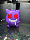 Front view of the purple Derpy Gengar figure with red eyes, a broad white grin, and a drool detail.