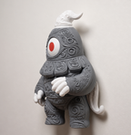 Angled display view of Dusclops decor against a light wall, showing its dimensional gray body and white accents.
