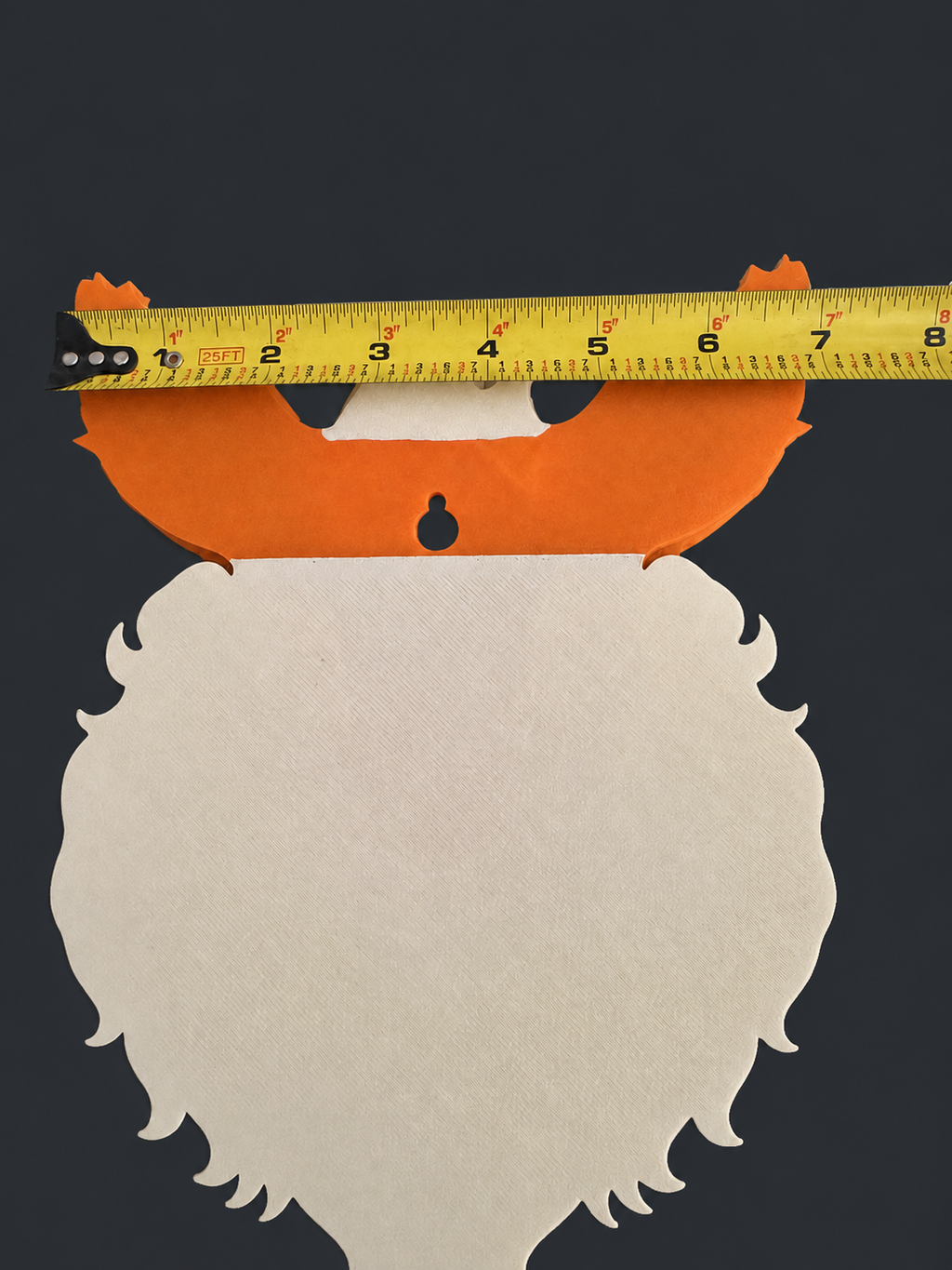 Back of Flareon wall art with a tape measure across its orange ears and visible keyhole hanger.