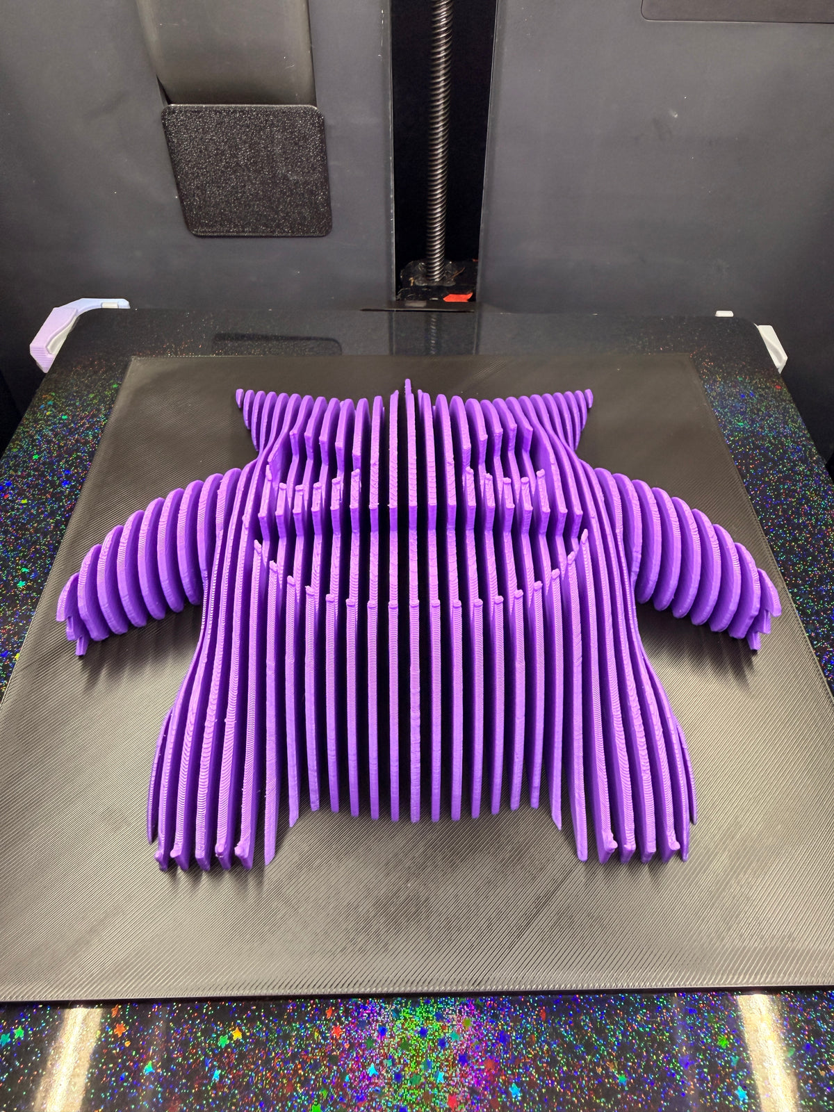 Angled view of Gengar optical illusion wall art lying flat, showing its dimensional purple silhouette.