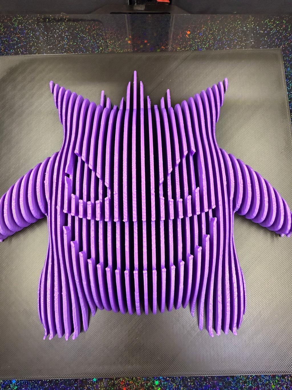 Close front view of Gengar optical illusion wall art showing the raised purple sections that form its eyes and grin.