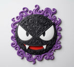 Gastly wall plaque with a black filigree face, white eyes and fangs, red mouth, and purple swirling border.