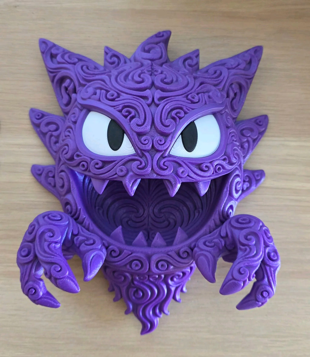 Purple Haunter wall plaque showing white eyes, an open mouth, raised filigree, and clawed hands.