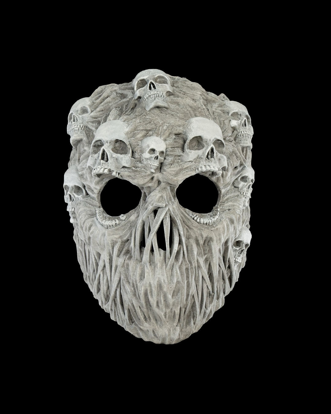 Front view of gray Ghoul Face Halloween mask with sculpted skulls, open eye holes, and twisted root-like details.