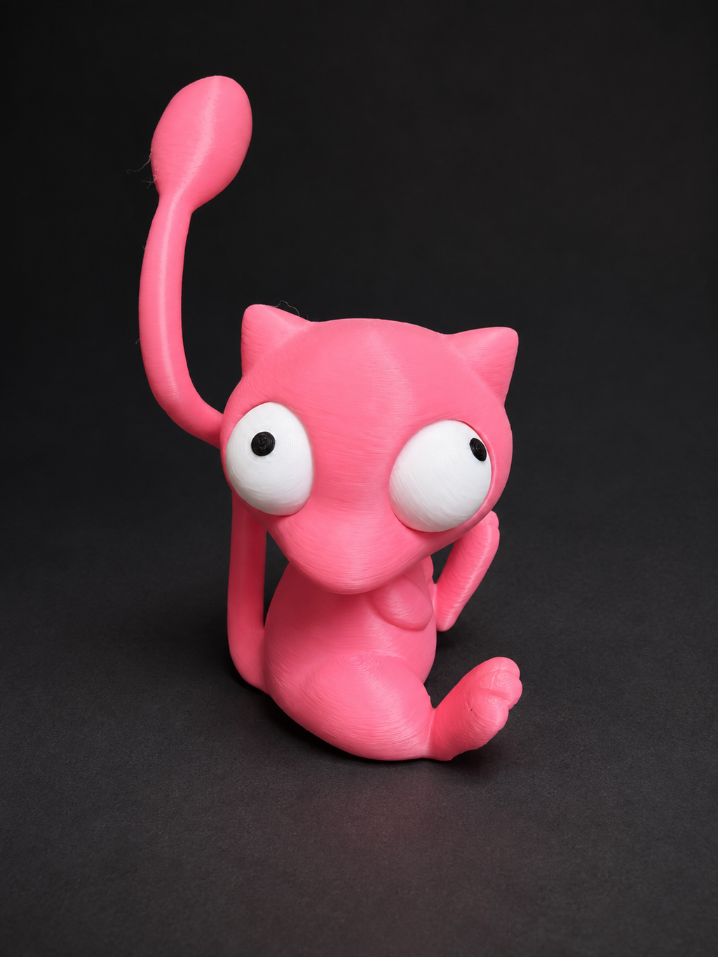 Angled view of pink Goofy-Eyed Mew with its movable eyes facing different directions.