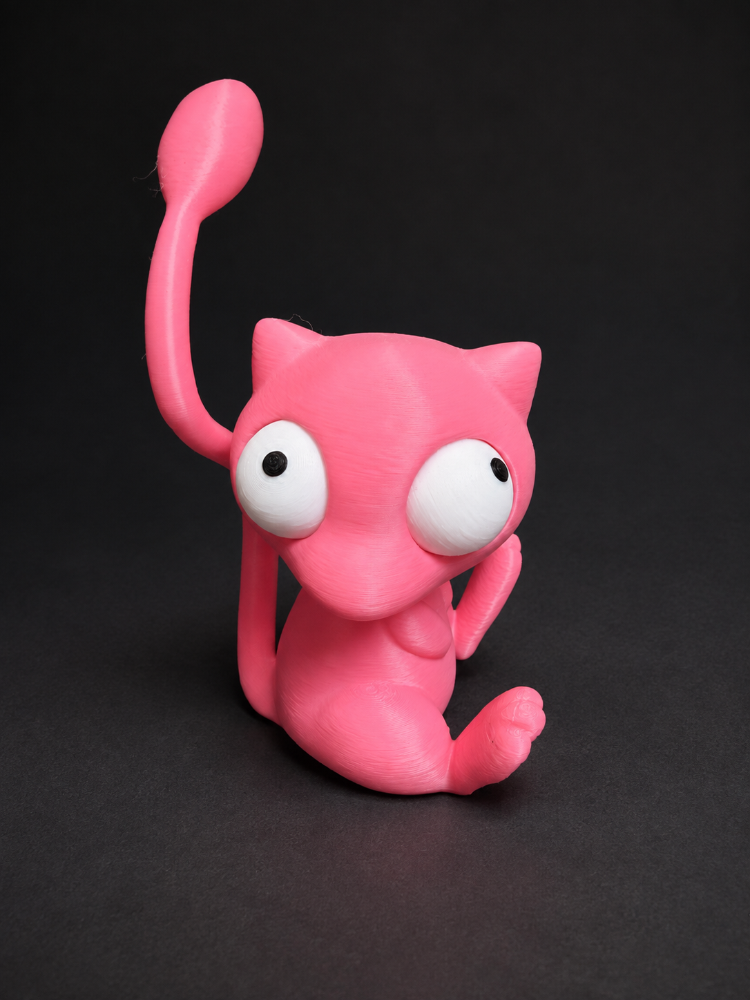 Angled view of pink Goofy-Eyed Mew with its movable eyes facing different directions.