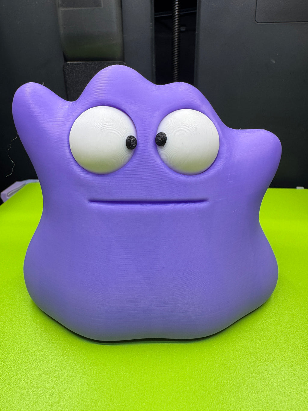 Front view of purple Googly-Eyed Ditto with both black pupils turned inward for a cross-eyed expression.