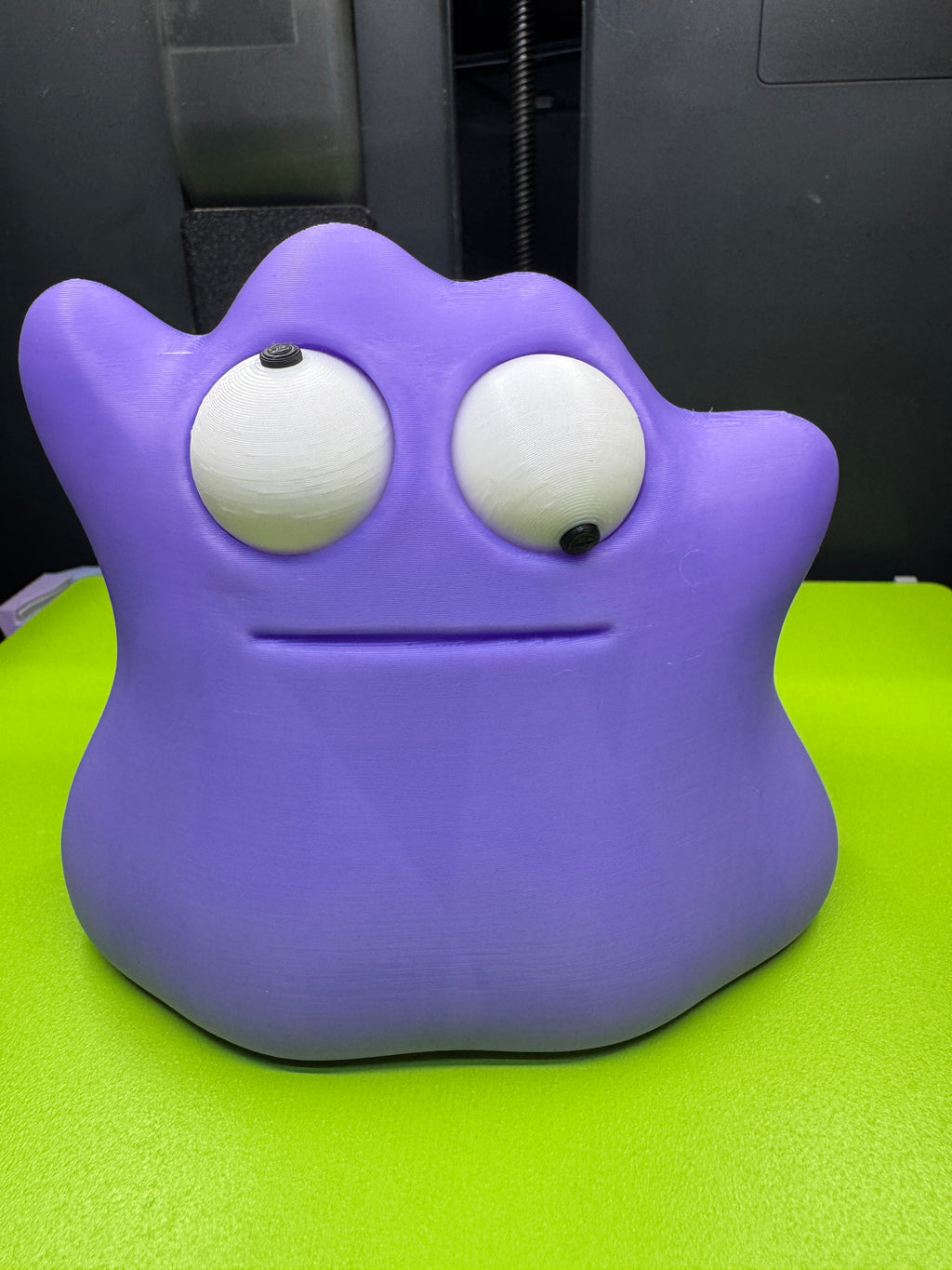 Purple Googly-Eyed Ditto with one pupil facing upward and the other downward, demonstrating its movable eyes.