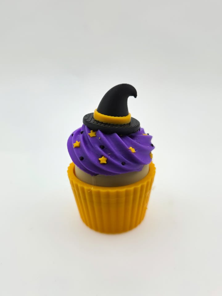 Purple decorative cupcake with black witch hat and yellow stars.