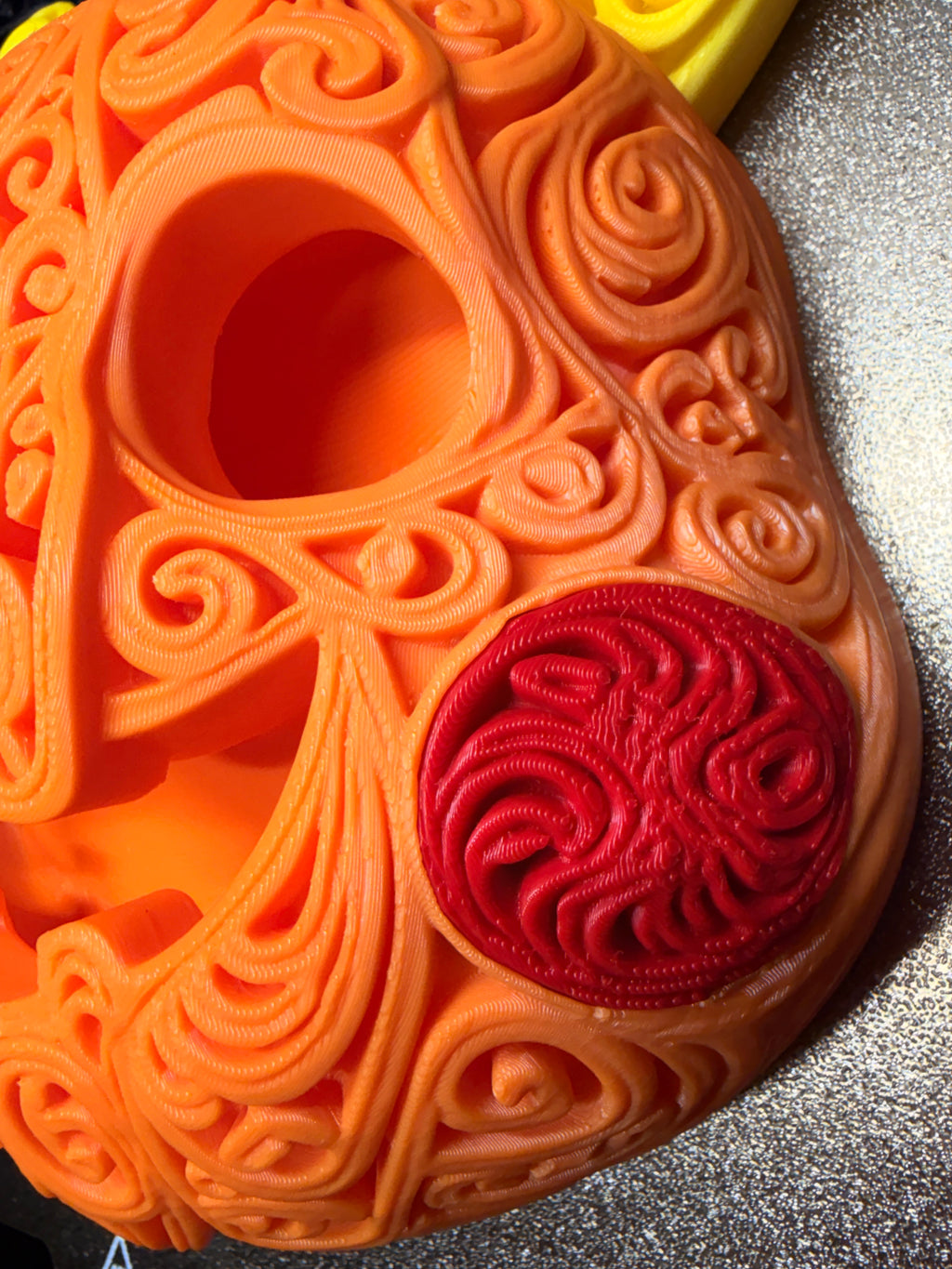 Detail view of the orange Halloween Pikachu pumpkin wall art showing raised scrollwork, a hollow eye, and a red patterned cheek.