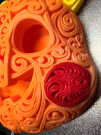 Detail view of the orange Halloween Pikachu pumpkin wall art showing raised scrollwork, a hollow eye, and a red patterned cheek.