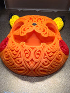 Angled front view of orange Halloween Pikachu wall art with hollow pumpkin eyes and mouth, yellow ears, and red filigree cheeks.