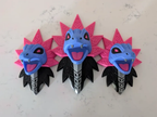 Front view of three-headed Iron Jugulis Pokémon wall art in blue, magenta, black and white with raised filigree.