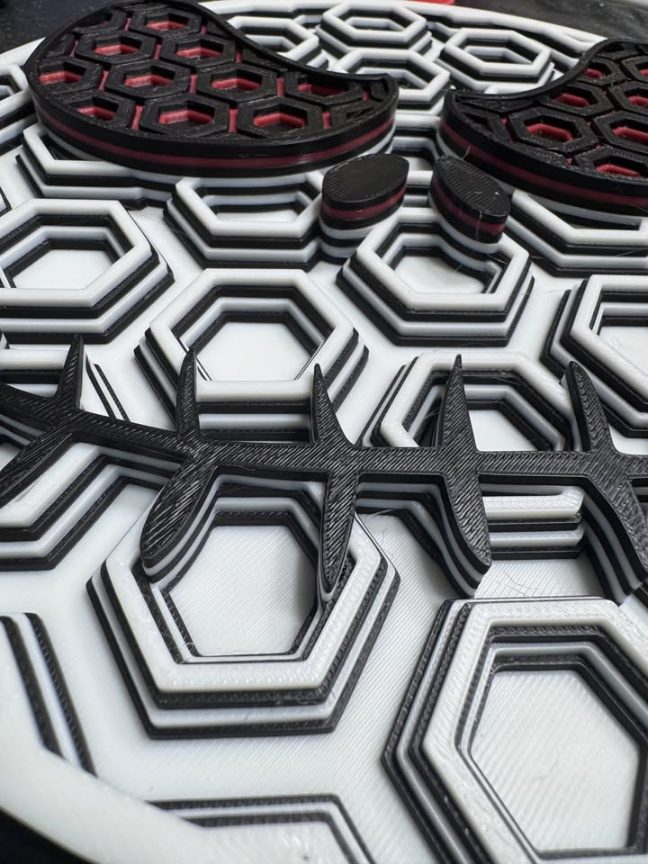 Angled close-up of Jack Skellington wall art showing raised hexagonal layers, a black stitched smile, and dark red eye accents.