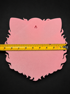 Pink back of Jigglypuff wall art showing a keyhole hanging slot and tape measure across its width.
