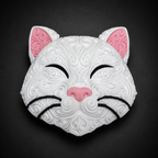 Front of white Korin cat wall art with raised filigree, pink ears and nose, and black closed eyes and whiskers.