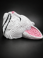 Side view of white Korin wall art showing its dimensional profile, pink ear, and raised filigree details.