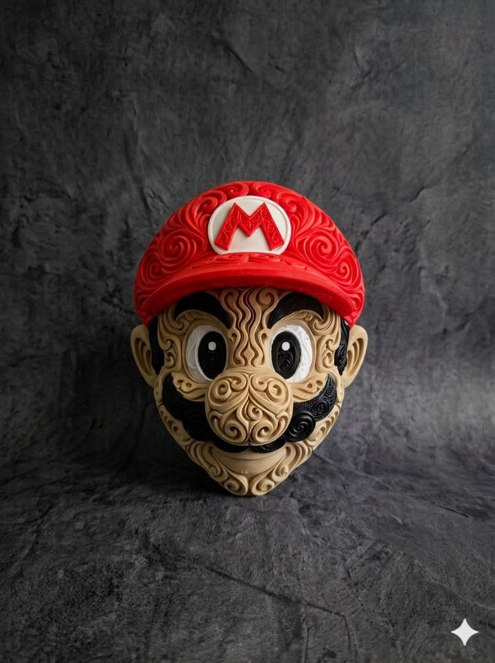 Front of Mario filigree wall art with red cap, tan face, and black mustache on a dark textured display surface.