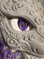 Close-up of Mewtwo wall art showing a purple glitter eye, white eye surround, and raised gray filigree texture.