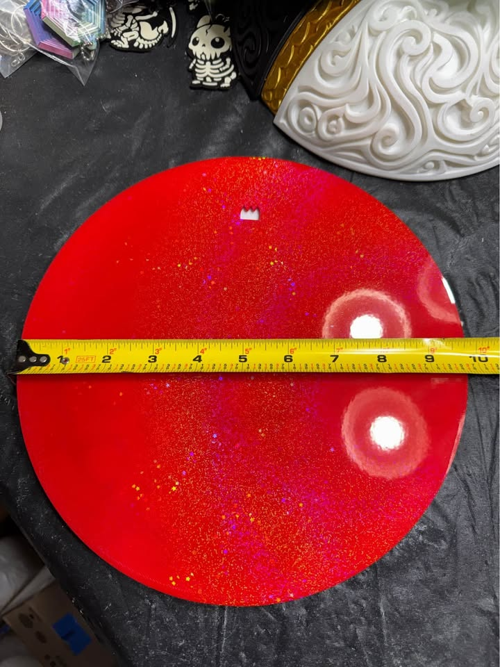 Red back of the Mosaic Poké Ball wall plaque with a hanging opening and tape measure showing approximately 10 inches across.