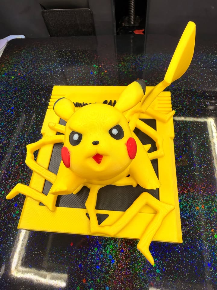 Angled front view of yellow Pikachu Game Boy wall art with red cheeks, black ear tips, and a raised lightning-bolt tail.