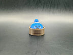 Blue Squirtle dumpling clicker with pink cheeks in a brown steamer-style base.