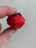 Red Pop Fidget held between fingers
