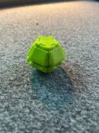Green Pop Fidget resting on a surface