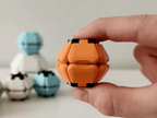 Orange Pop Fidget being squeezed