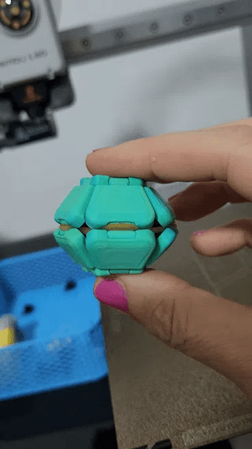 Turquoise Pop Fidget being squeezed